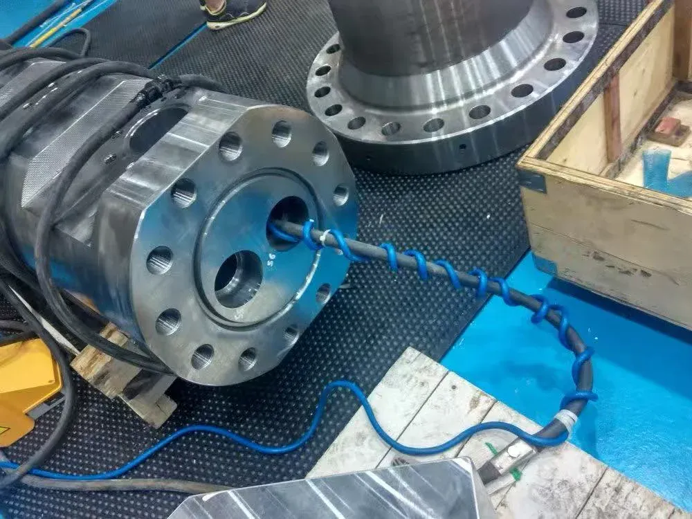 Cable-wrap magnetization: cable threaded through a bore in the end flange of the valve body