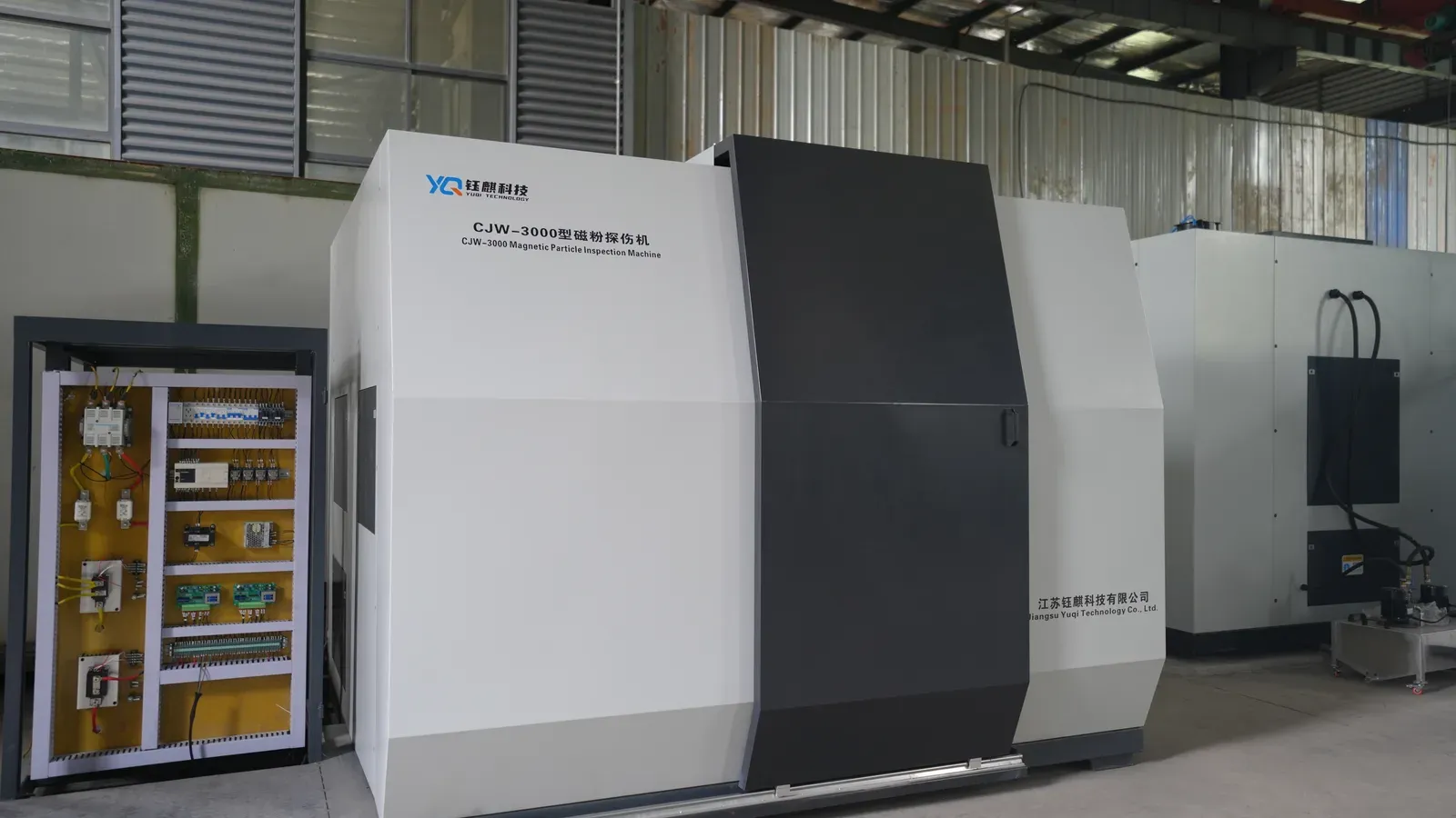 CJW-3000 magnetic particle inspection machine beside its open electrical cabinet