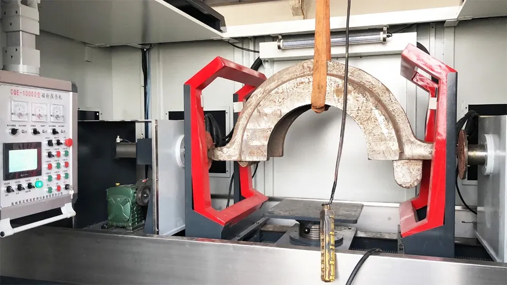 Workpiece between the magnetizing coils of a general-purpose magnetic particle testing machine