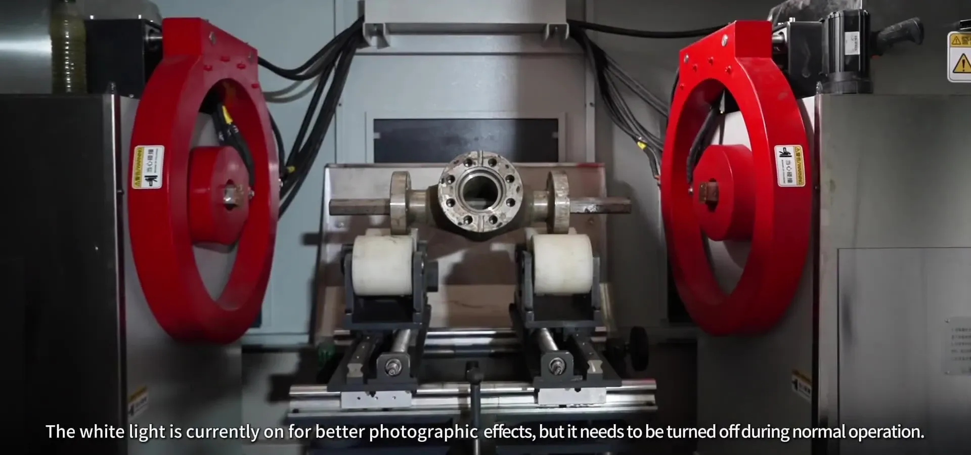 Part between the red magnetizing coils of a CQE-15000 magnetic particle inspection machine