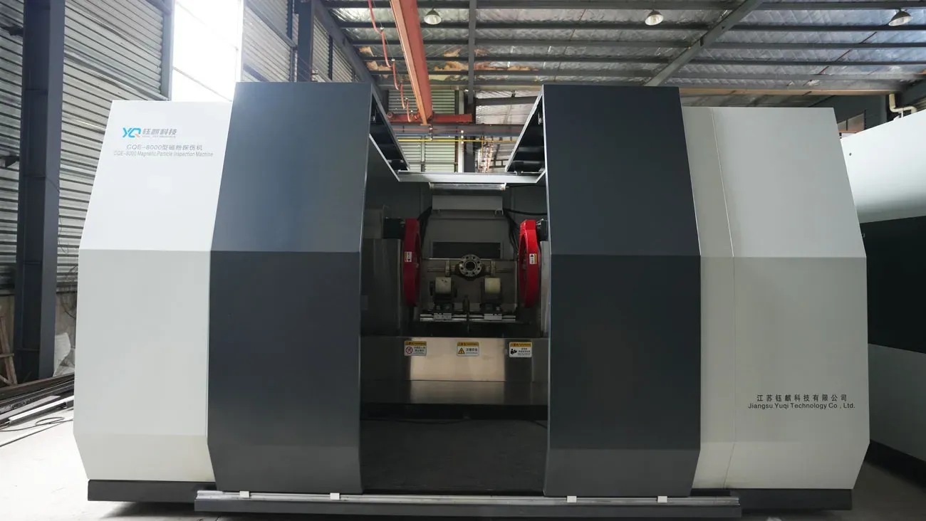 CQE-8000 with its doors open, an oilfield part on the support rollers between two magnetizing coils