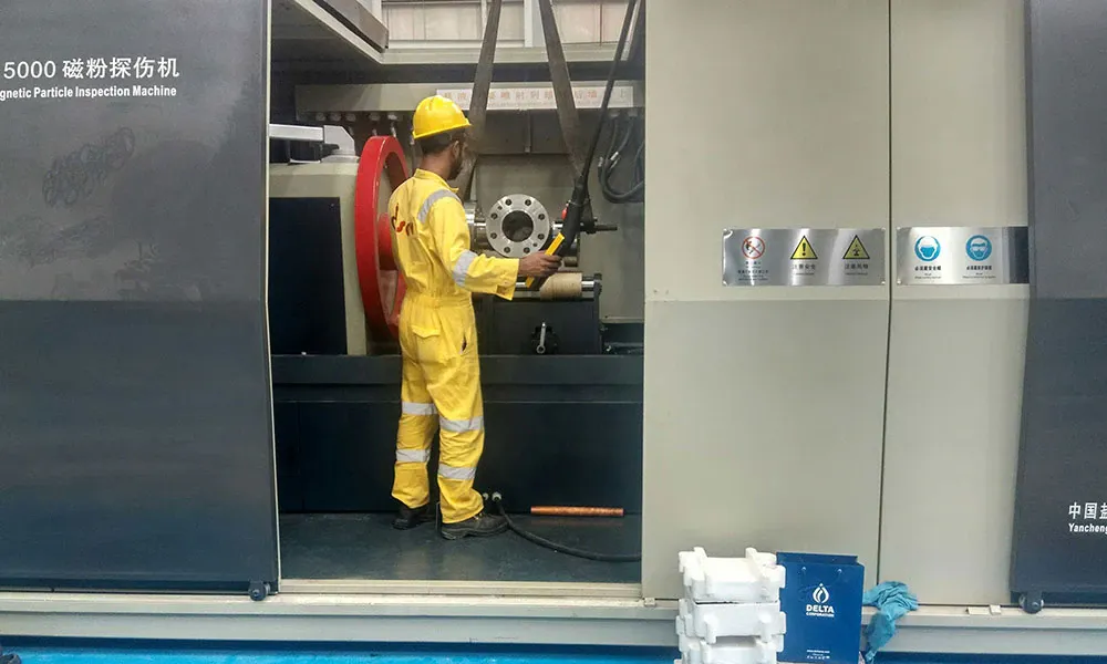 Operator working at the open inspection chamber of a CQE-15000 machine